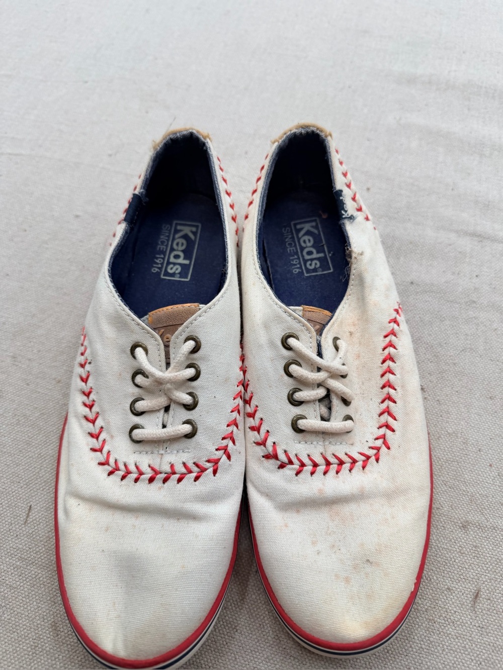 Keds white canvas baseball sneakers with navy interior and red sole trim